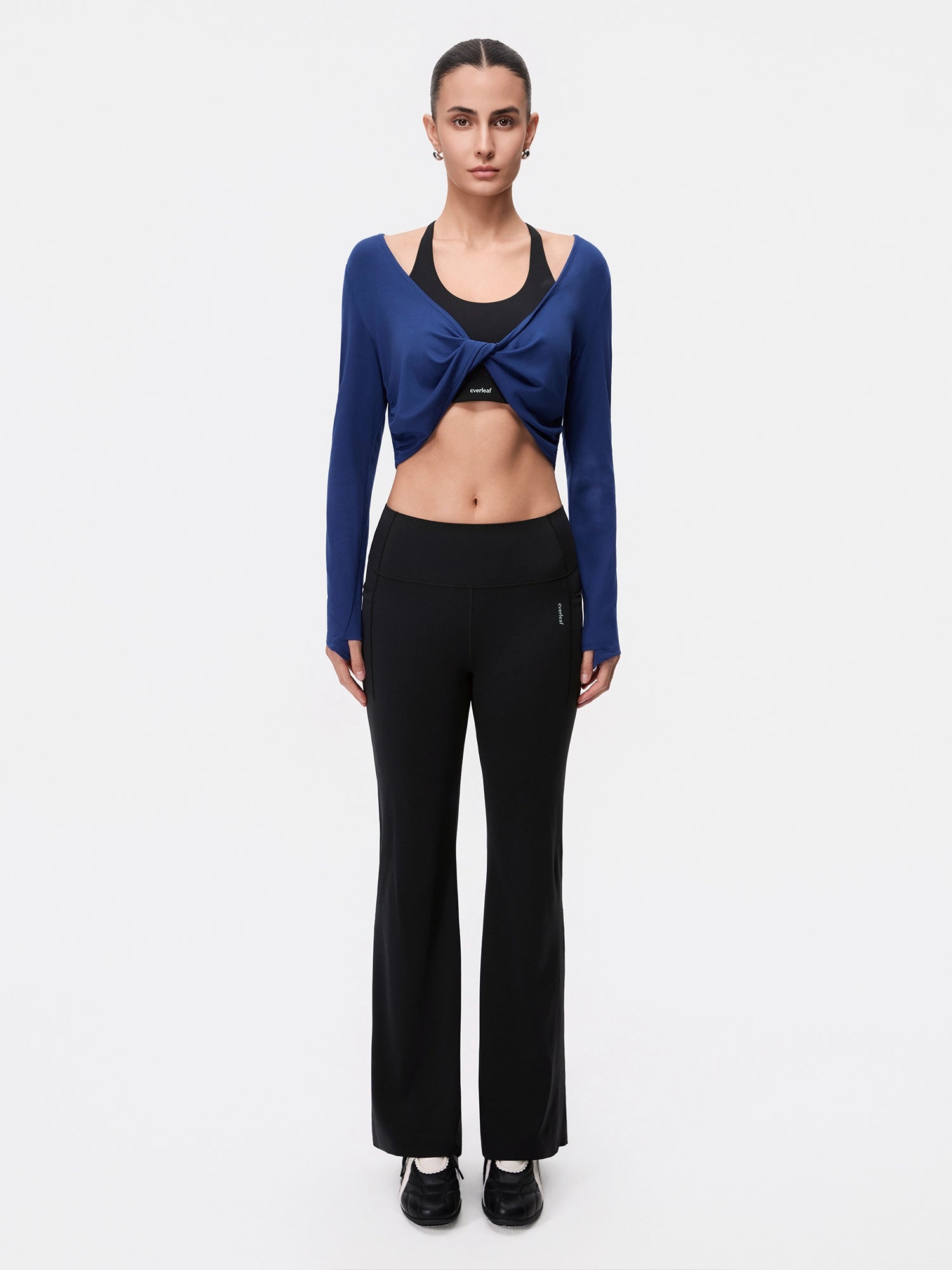 Image of Model wearing the Estate Blue reversible ballet twist cardigan, full-body front view