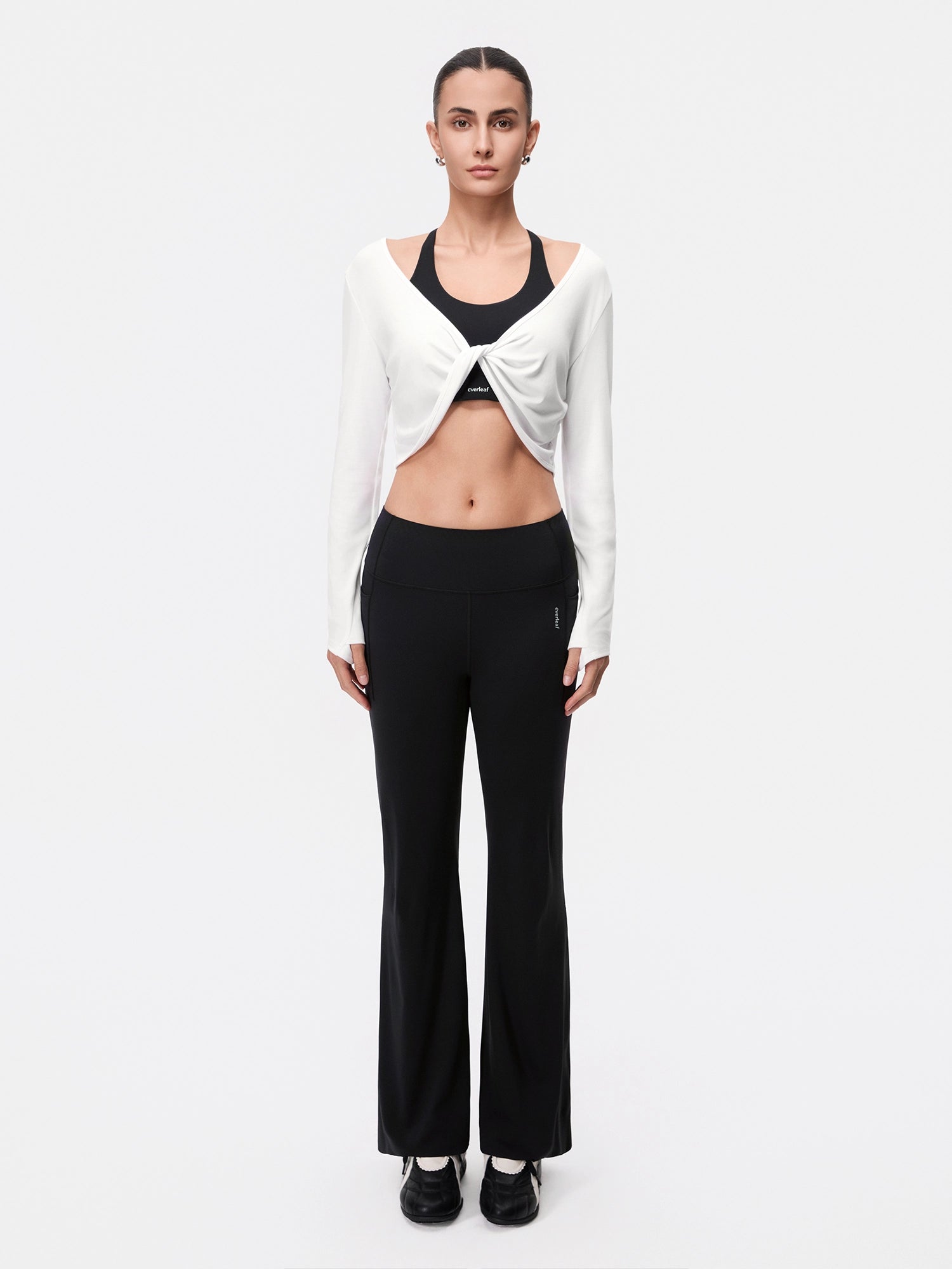 Image of Model wearing the Cloud White Reversible Ballet Twist Cardigan, full-body front view